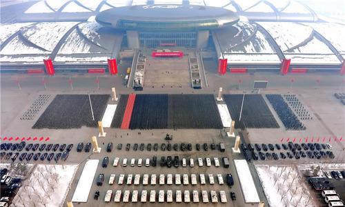 2.自治区反恐维稳誓师大会现场。升机在空中盘旋，一辆辆军车、装甲车、摩托车列队待发。新疆法制报记者 郑旭磊 摄