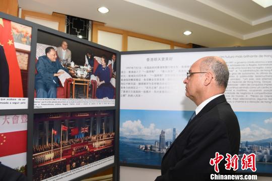 图为一位外国友人现场观看香港图片展。　莫成雄 摄