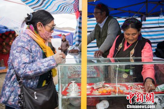 连续参加了26届物交会的69岁老人罗布夫妇正在打理他们的“小店”。何蓬磊 摄