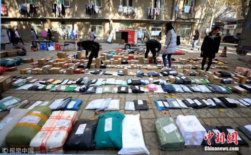 11月13日消息，“双十一”刚刚过去，大量快递包裹便涌入全国多地高校，场面壮观。图为11月12日，济南山东师范大学千佛山校区快递包裹如潮水般涌入校园。据快递员了解，当日校园快递包裹数量比平时翻了两倍多。为了让学生更方便有秩序查收包裹，快递人员将所有包裹在地面一次铺开，并一一扫码通知个人，学生收到短信后凭编码取快递，方便，安全。 万象 摄 图片来源：视觉中国