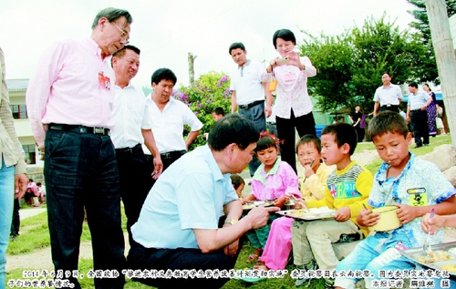 2014年6月9日，全国政协“推进农村义务教育学生营养改善计划贯彻实施”委员视察团在云南视察。图为委员实地察看孩子们的营养餐情况。  本报记者 廉维亮 摄