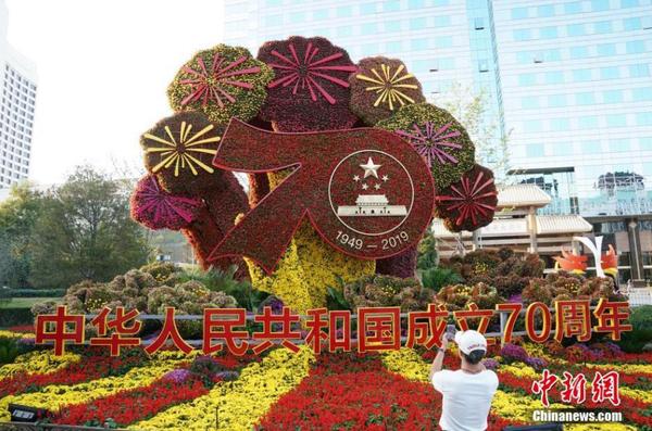 9月24日，市民在位于北京长安街沿线的“壮丽70年”主题花坛前拍照留念。随着国庆节临近，北京街头主题花坛陆续亮相。中新社记者 张兴龙 摄