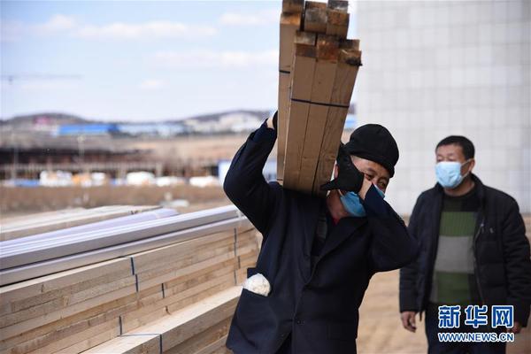 4月10日，工人们在搬运建材。黑龙江省绥芬河市4月6日开始建设方舱医院。建设方介绍，由办公楼改建的方舱医院，可提供600余张床位，预计11日启用。 新华社记者 董宝森 摄