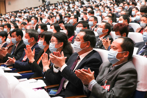 委员们对大会召开报以热烈的掌声。覃文宇摄
