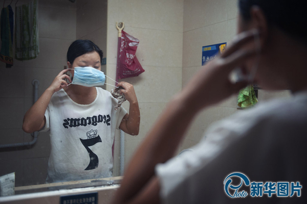 进入李真的病房前，向华用盐水擦洗身体消完毒，她简单地拨了下头发，麻利地对着镜子戴上口罩，让人有些难以联想到那个穿着婚纱打扮精致的姑娘。