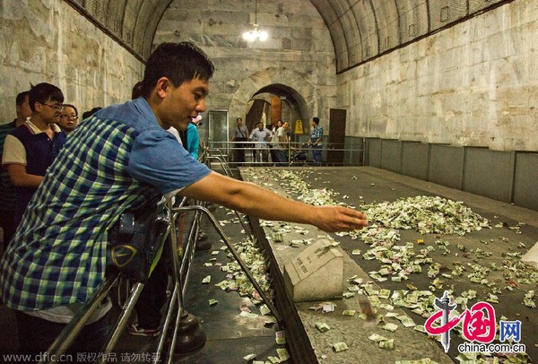 中国网8月15日讯 2014年8月14日，北京昌平区，5A级景区明十三陵定陵地宫内，历史文物上游客祈福所投过去的钱币堆成了小山，没有工作人员制止清理。