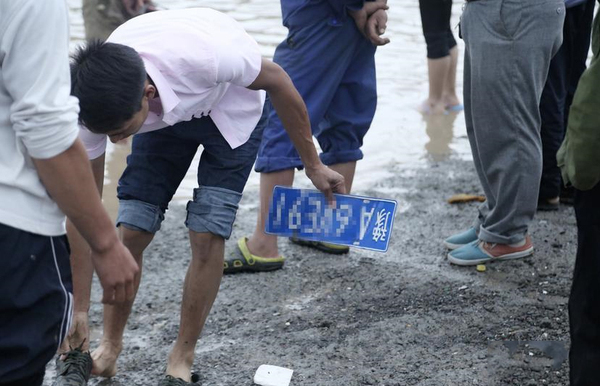 道路积水严重村民水中捞车牌卖钱-一个要价100元3