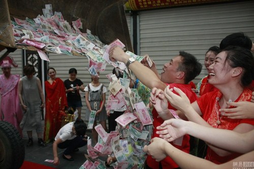 　图为景区工作人员将铲车运来清点钞票。