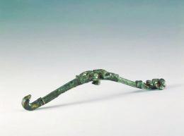带钩长16.2cm，通体鎏金，用高浮雕手法呈现动物装饰。带钩前端为鸟首钩，后端装饰猴纹，猴腿一立一弯曲，双爪捧握食物。带钩正中饰有一只长耳卧兔，形态尤为生动。