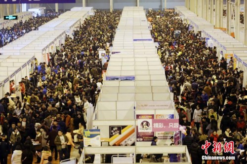 资料图：2月19日，山东省潍坊市，求职者在人才招聘会现场寻觅适合自己的工作岗位。当日，“2016年山东半岛城市群(潍坊)春季人才交流洽谈会”在潍坊金宝国际会展中心举行，742家用人单位前来进行招聘，提供岗位4万余个，吸引了5万多名求职者前来。 图片来源：视觉中国