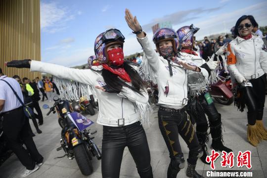 图为女车手赛前随着音乐热身。　刘文华 摄