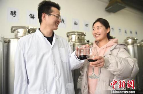 男生把自酿的红酒送给女生。　侯庆 摄
