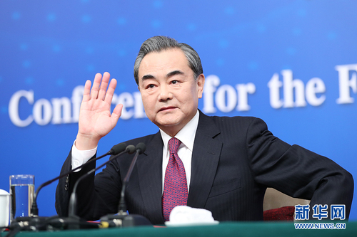 图为外交部部长王毅向记者示意。