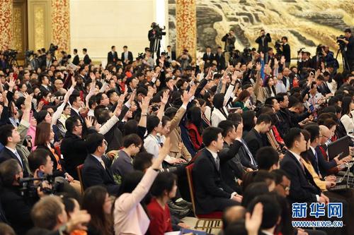 这是记者在举手提问。 新华社记者金立旺摄