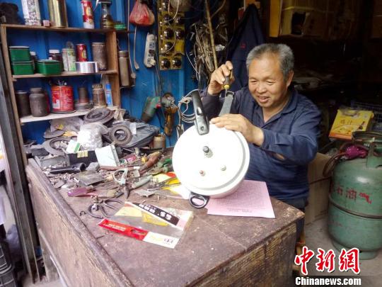 图为陈上付在修理高压锅。　吴苏梅 摄