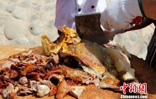 牛肉被厨师分割成大块，再用手斧剁成小块，分装到小盘中。　史玉江　摄