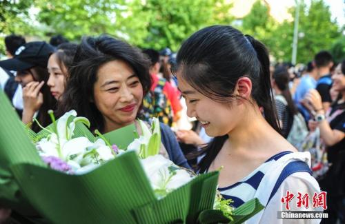 资料图：山东济南众多考生手捧鲜花在家长的簇拥下欢快告别高考。<a target='_blank' href='http://www.chinanews.com/' _fcksavedurl='http://www.chinanews.com/'></table>中新社</a>记者 张勇 摄