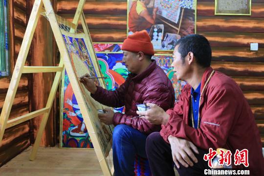 图为高佐甲泽与徒弟阿阿扎巴绘制唐卡。　王鹏 摄