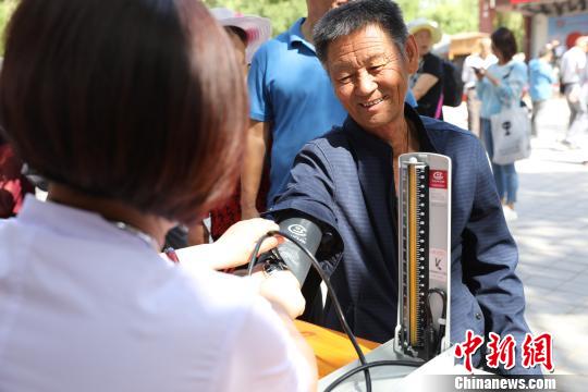 义诊医生在为市民测量血压。　胡耀荣 摄