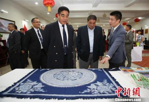中国侨网普拉哈德将军等观赏中国贵州艺术家杨启英的蜡染桌布作品《蝴蝶翩翩》。　张晨翼　摄