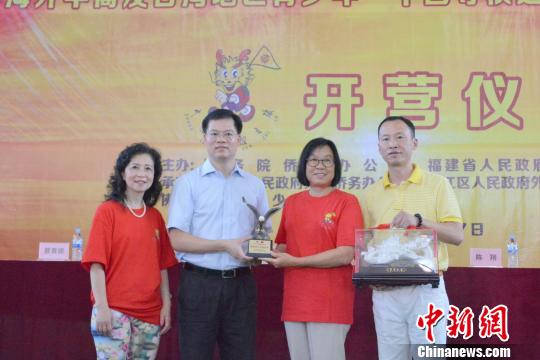 中国侨网7月9日，2018年海外华裔及台湾地区青少年“中国寻根之旅”夏令营——福建洛江营开营式上，主办方互赠纪念品。　孙虹　摄