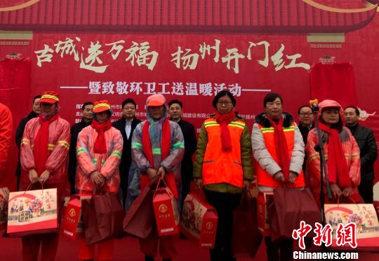 图为现场向获得“金扫帚”奖的环卫工代表赠送春节礼包。　崔佳明 摄