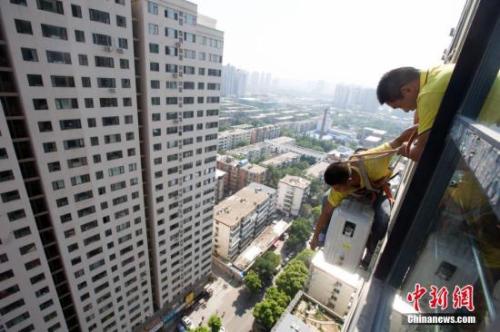 资料图：在山西太原，空调安装工程师顶着酷暑高温，为市民安装空调。<a target='_blank' href='http://www.chinanews.com/'>中新社</a>记者 张云 摄
