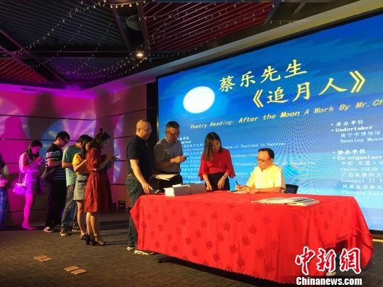 图为泰王国驻南宁总领事馆总领事蔡乐·蓬蒂窝拉卫为诗集《追月人》读者签字留念。　　陈秋霞 摄