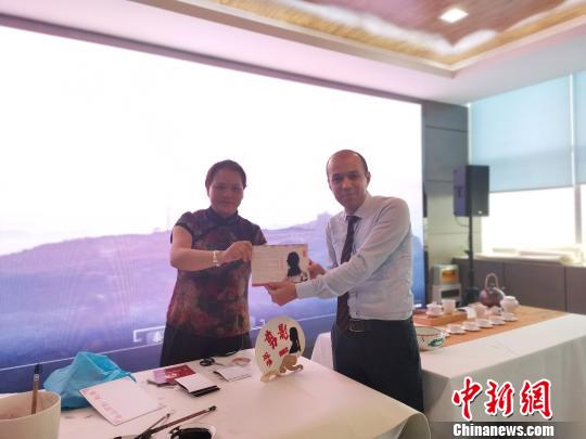 图为，在庆祝新中国成立70周年外国专家座谈会暨驻济外国人才中秋节沙龙观上，外国专家展示获赠的剪影作品。　孙宏瑗 摄
