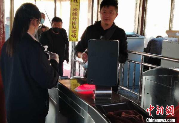 图为游客进景区前测量体温。甘肃嘉峪关市文旅局供图