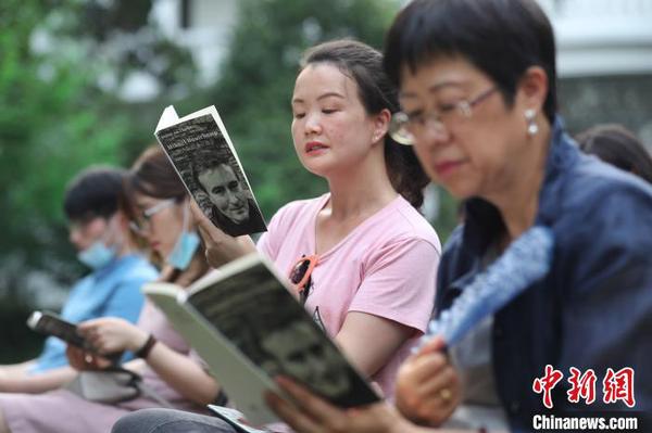 现场观众阅读、品味诗歌的魅力。　张亨伟 摄