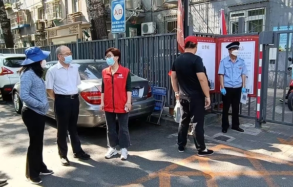 汤钦飞主席到东直门街道新中街社区检查小区出入口登记扫码情况